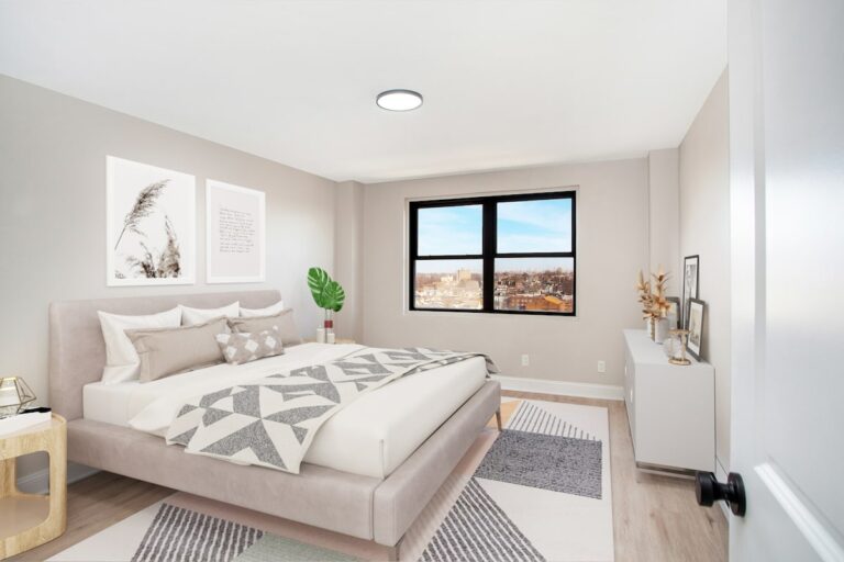Large bedroom with natural lighting and hardwood style flooring